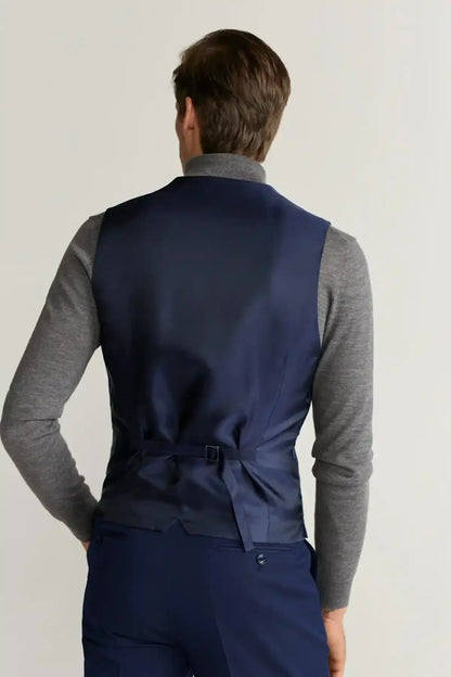 Back view of blue suit vest with adjustable waist tie, gray long sleeves