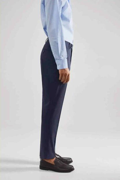 Men's indigo blue dress trousers, side view with belt loops and cuffless hem