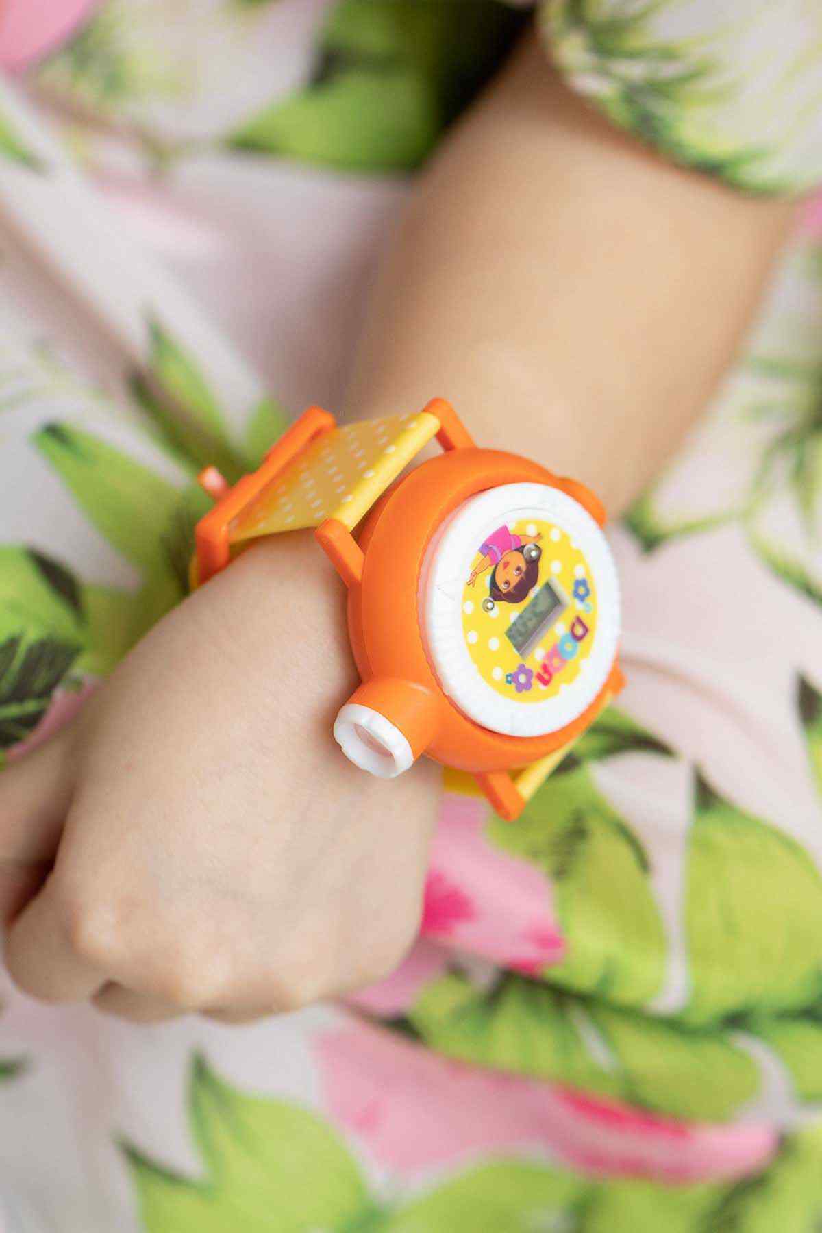 Orange kids wristwatch on wrist, round dial with Dora character, yellow strap