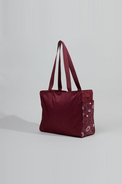 Burgundy tote bag with long handles and patterned side pocket