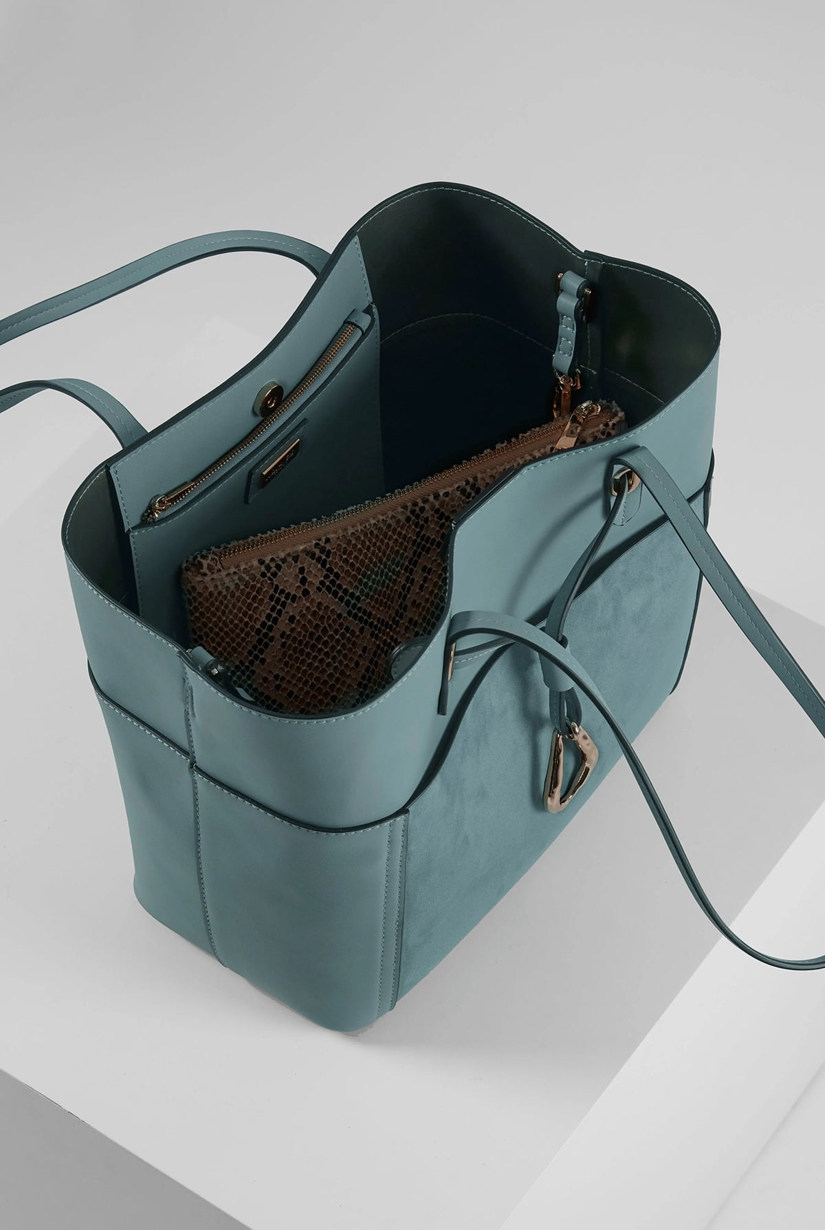 Luella blue tote bag open interior with snakeskin-pattern pouch and dark lining