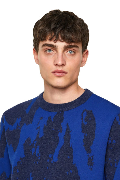 Blue Diesel crewneck sweater with dark abstract pattern, close-up collar.