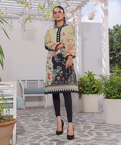 Long patchwork tunic with black leggings; yellow base with red florals and trim