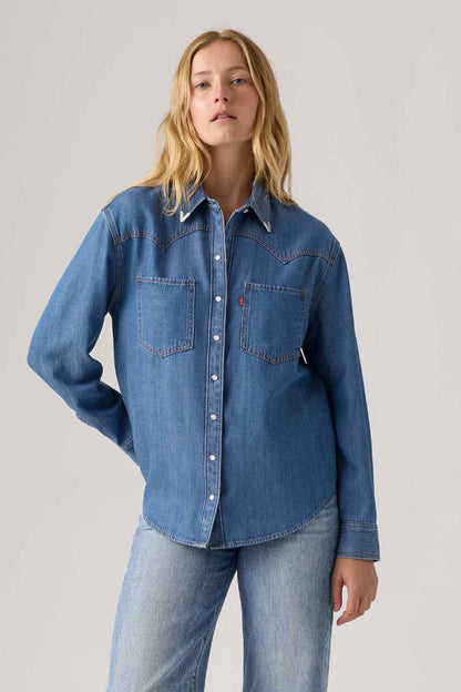 Women's Levi's med indigo denim button-up shirt with pointed collar and chest pockets