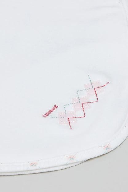Baby blanket edge close-up with red and blue geometric embroidery stitching