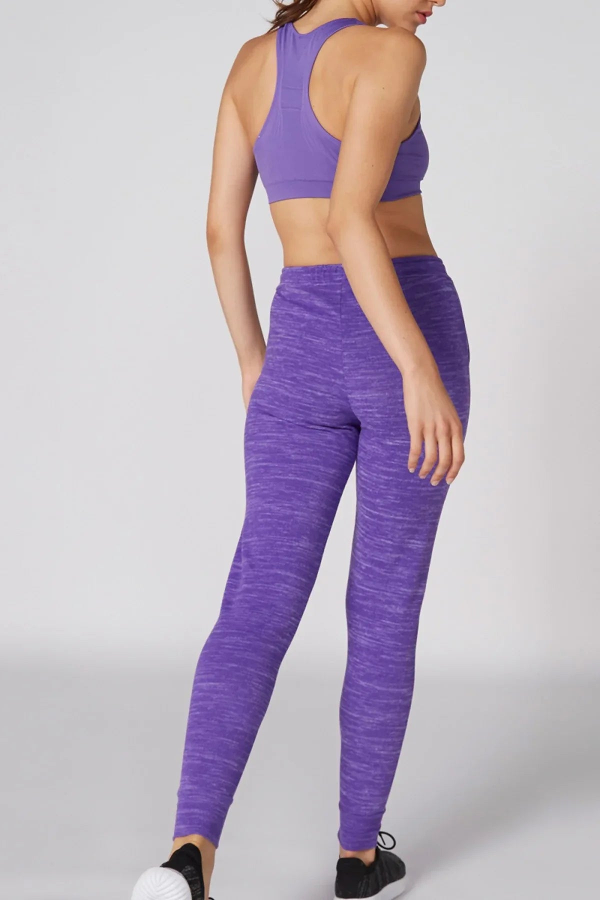 Purple sports bra and leggings set, back view with racerback top and textured tights