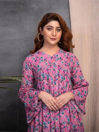 Pink floral long-sleeve midi dress with V-neck; hands clasped at waist