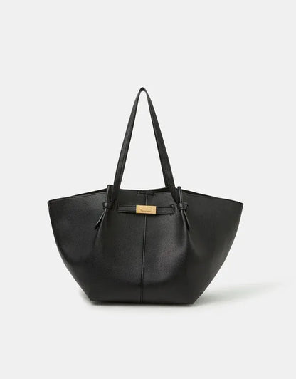 Black tote bag with top handles, gold clasp, and centered vertical seam