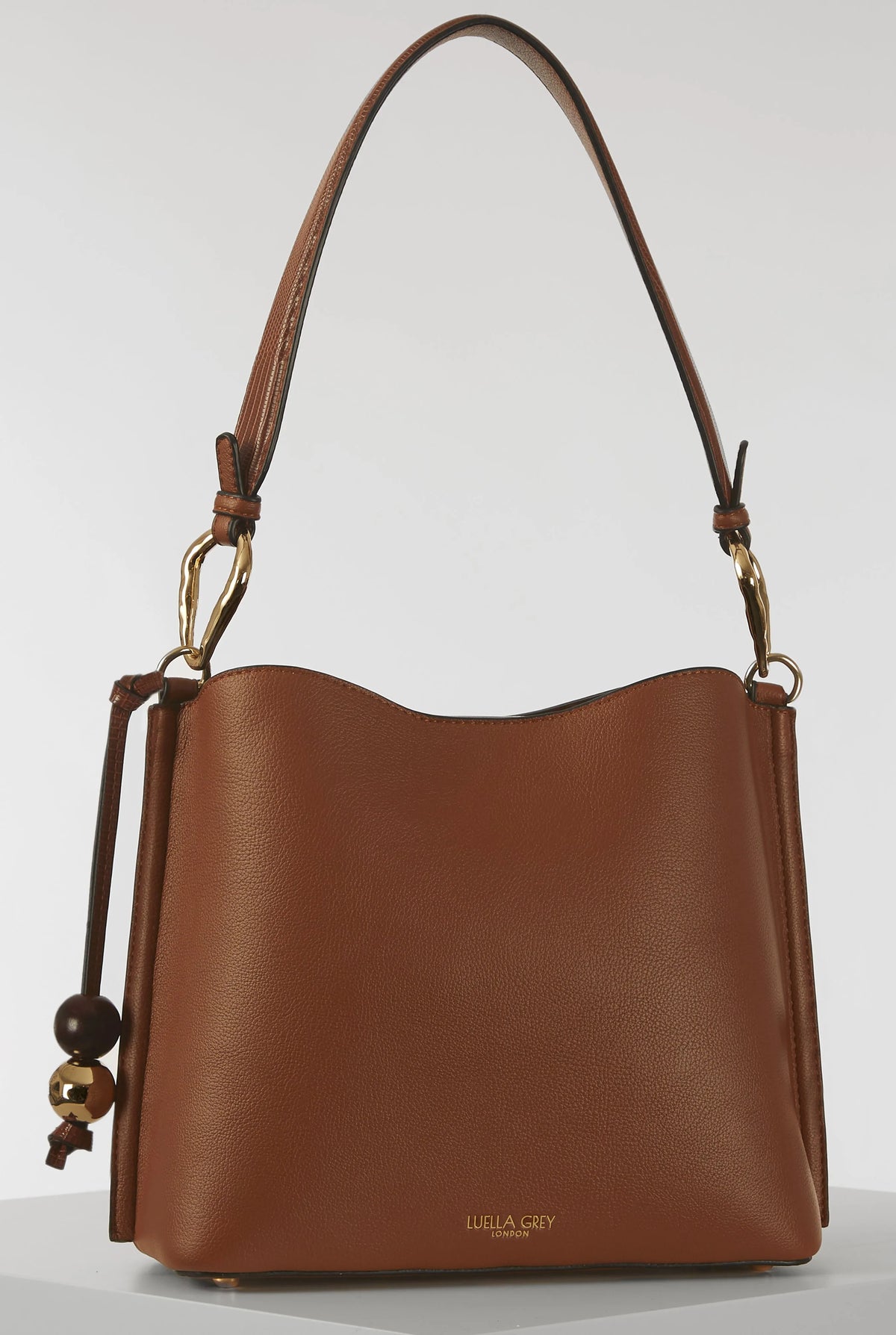 Brown leather hobo bag with curved top, double handles, and gold accents