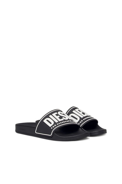 Black slide sandals with white-bordered DIESEL logo strap