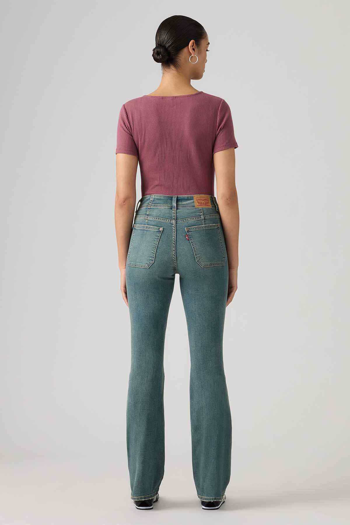 Levi's mid-indigo bootcut jeans, back view with two rear pockets and yoke