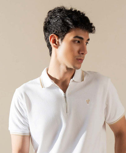 White fitted polo shirt close-up: quarter-zip collar, short sleeves, small embroidered logo