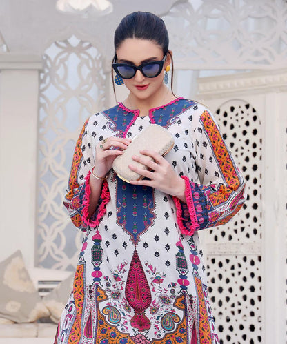 Printed long tunic with V neckline, colorful boho border, paired with dark blue pants