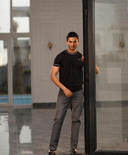 Men's fitted black t-shirt with white-trim collar and sleeve cuffs