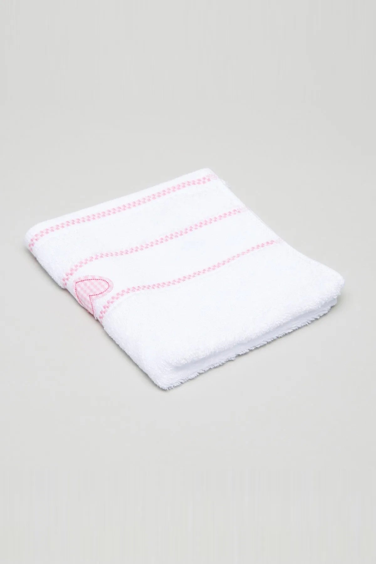 Folded white baby blanket with pink striped border