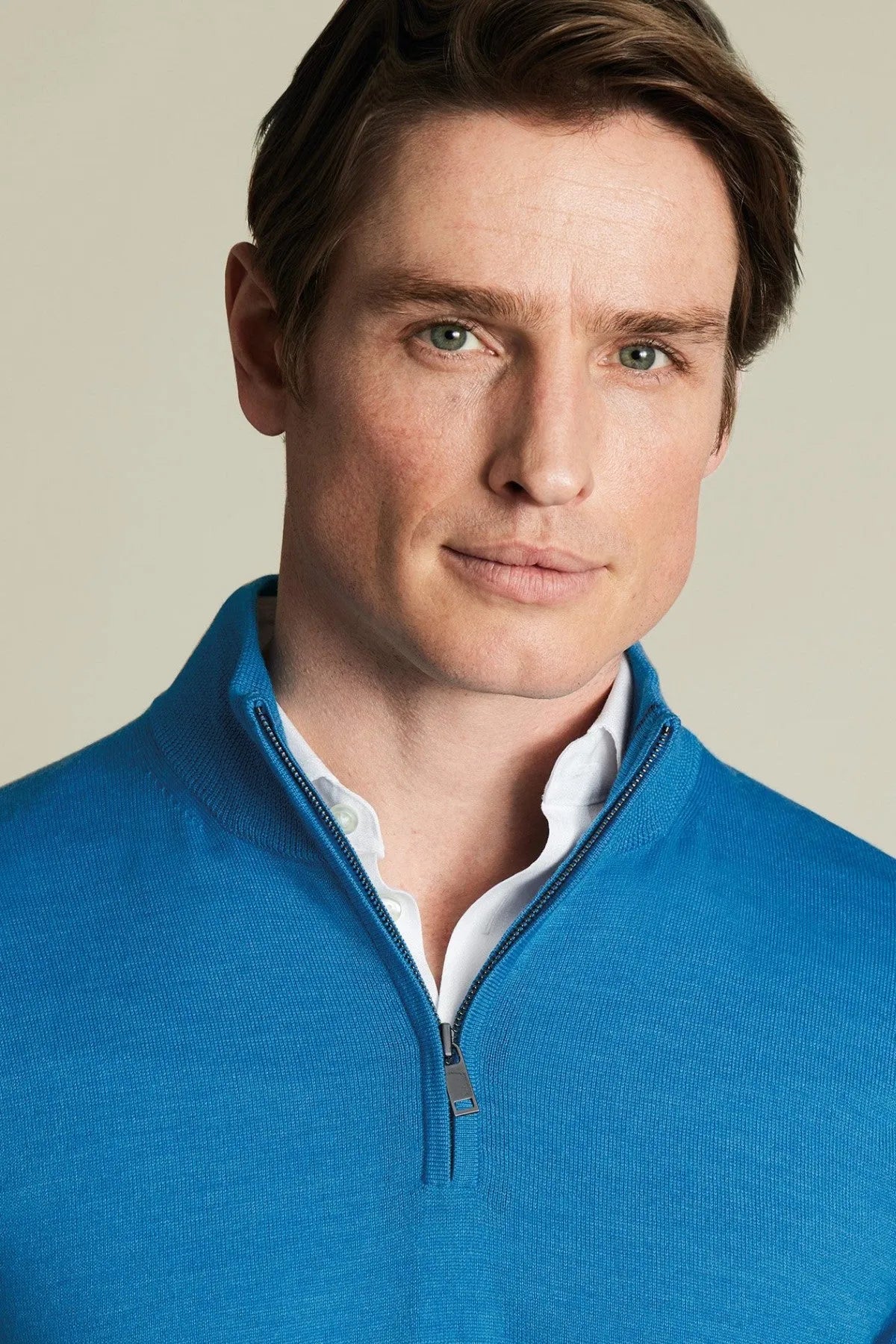 Blue knit quarter-zip sweater with zip placket and light collared neckline