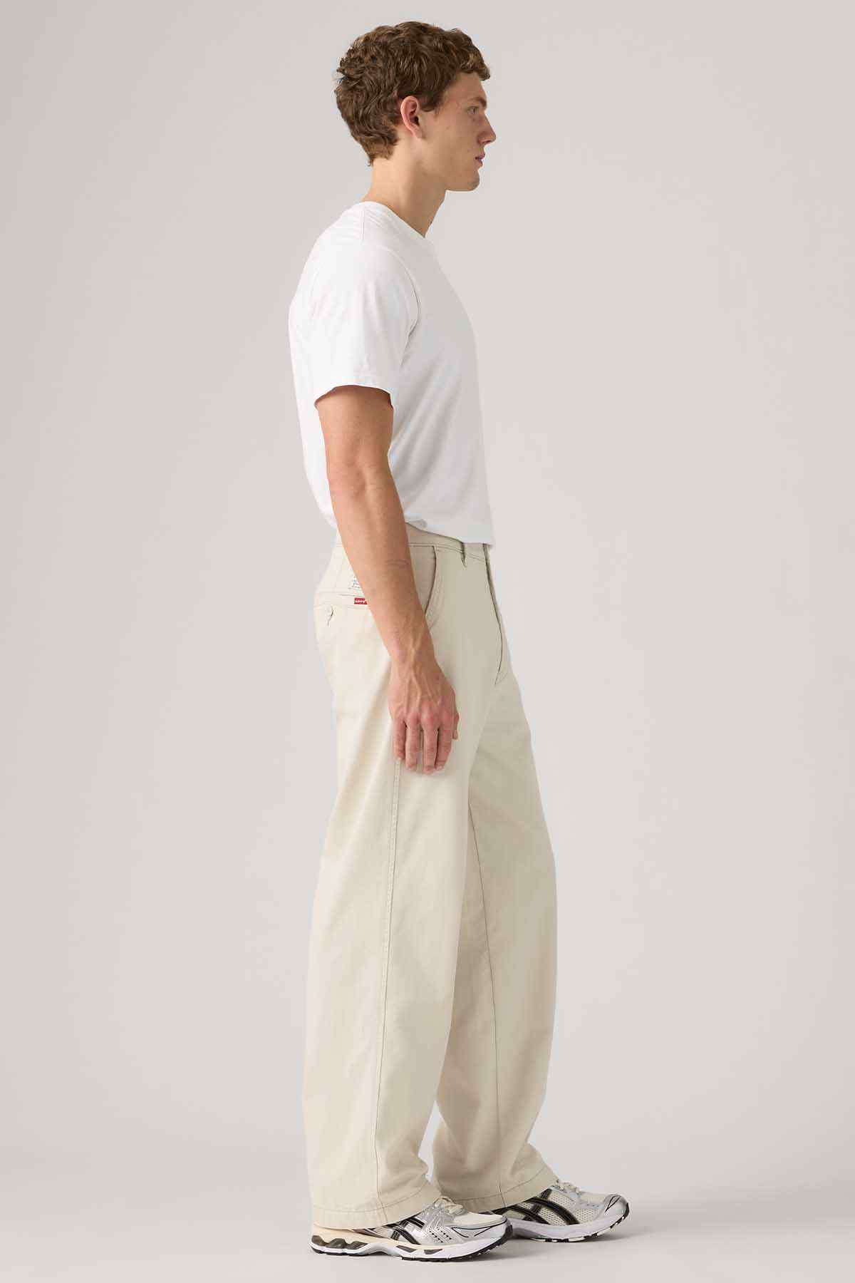 Levi's white crew-neck T-shirt with light beige pants, side view