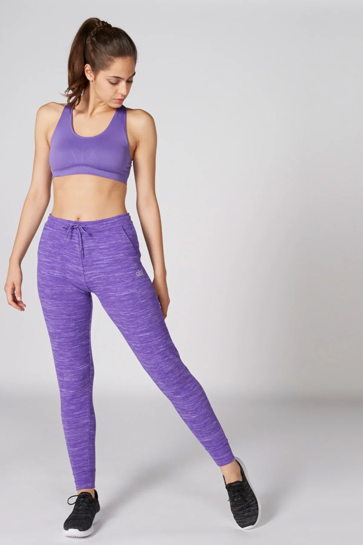 Purple sports bra and leggings set, racerback crop top and tapered full-length pants