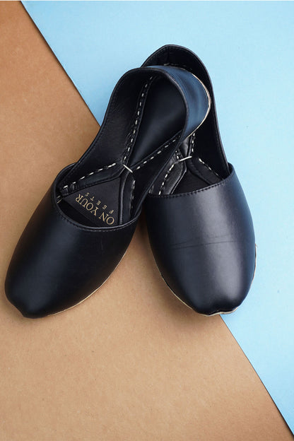 Black leather slip-on flats with round toe and contrast stitching