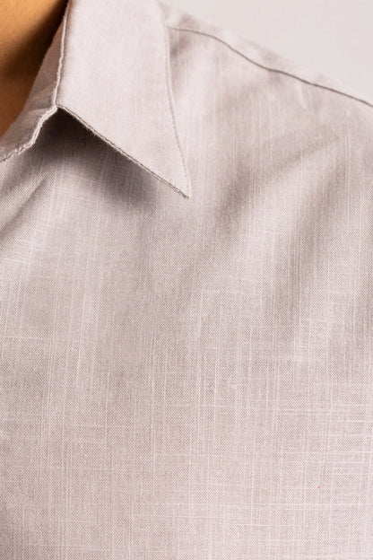 Close-up of grey button-up shirt fabric and collar stitching