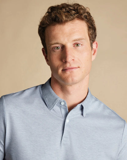 Light blue polo shirt with pointed collar and buttoned neckline