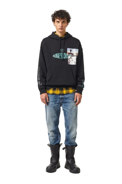 Black Diesel hoodie with front graphic, worn with blue jeans and dark boots