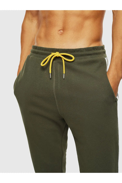 Green track pants with elastic waist and yellow drawstring