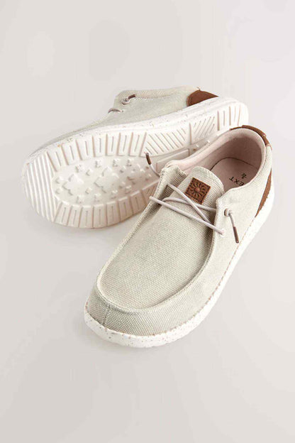 Beige canvas sneakers with lace-up front and speckled rubber sole