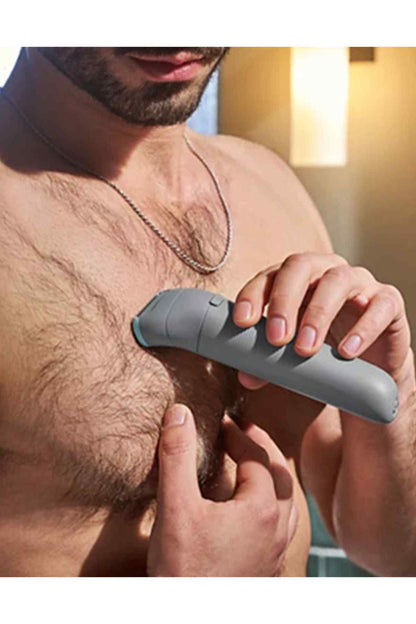 PHILIPS electric shaver held over chest, gray body with blue foil head