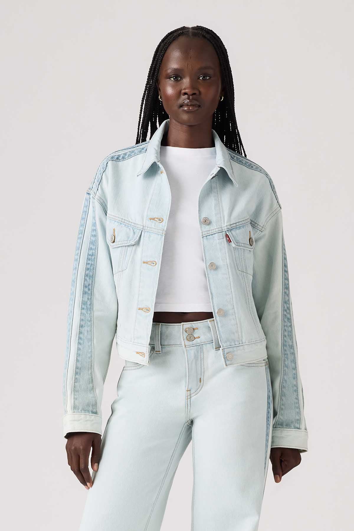 Light blue denim jacket with button front, chest pockets, and dropped shoulders