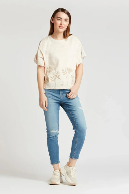 Light blue cropped distressed jeans with ripped knee details and rolled cuffs