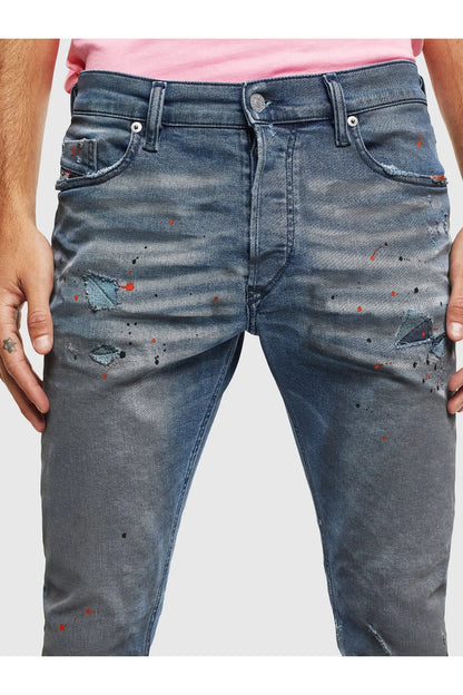 Indigo wash jeans with paint splatter, belt loops, button fly, and side pockets