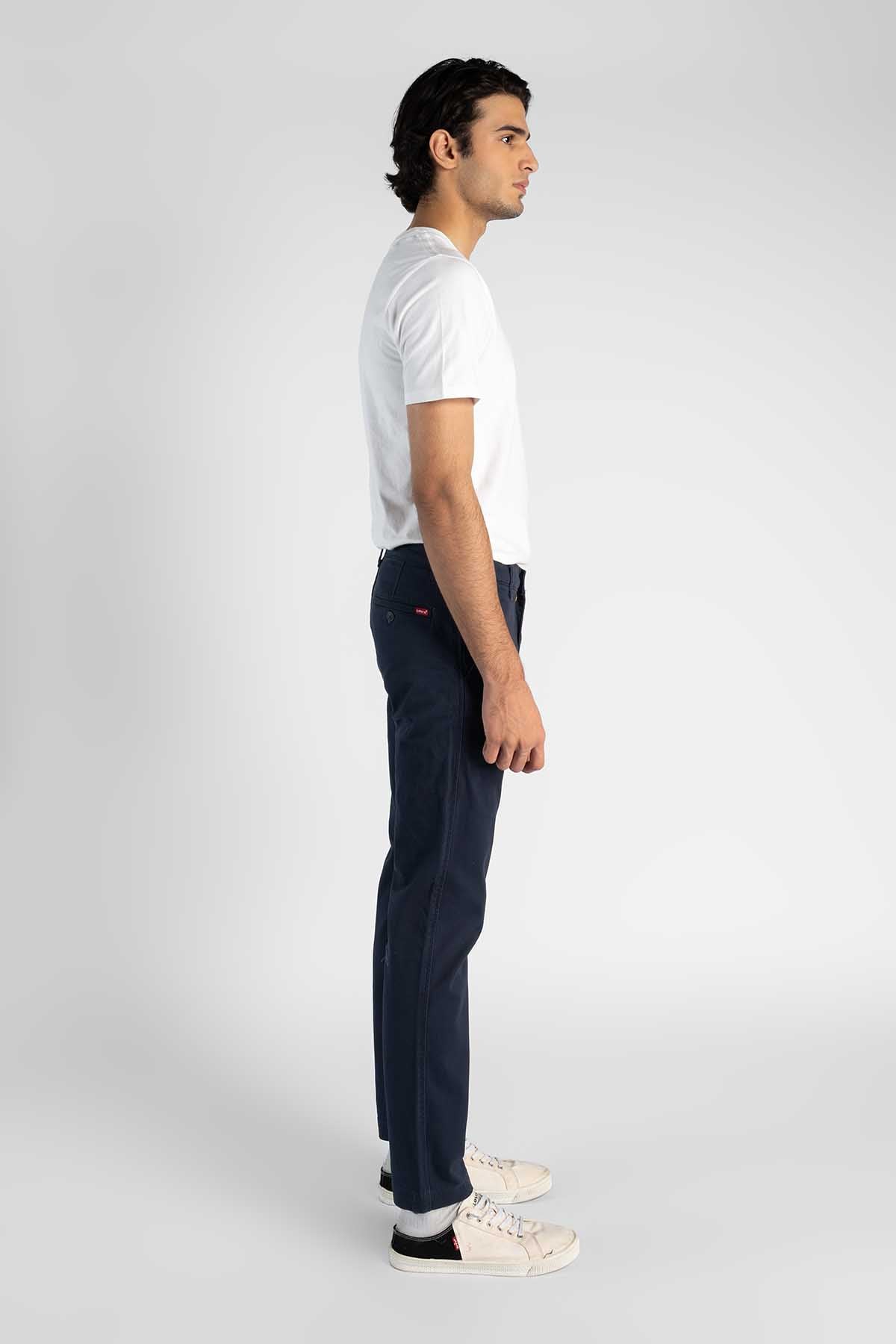 Dark navy jeans, side view with belt loops and straight tapered fit