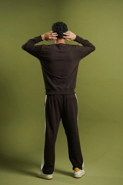 Dark brown knit loungewear set with long sleeves, jogger pants, and white soles