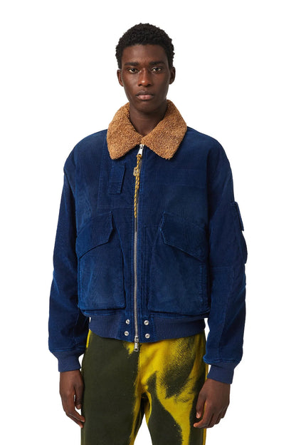 Diesel blue denim jacket with tan shearling-style collar, zip front, flap pockets