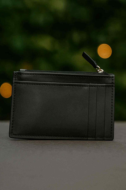 Black leather card holder front view with card slots and zip-top closure