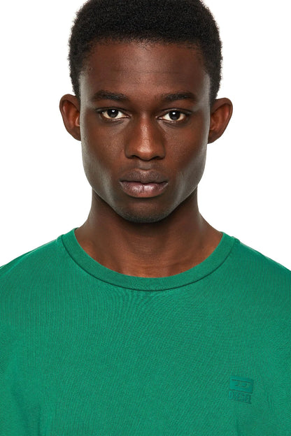 Green Diesel crew-neck T-shirt close-up with chest logo patch