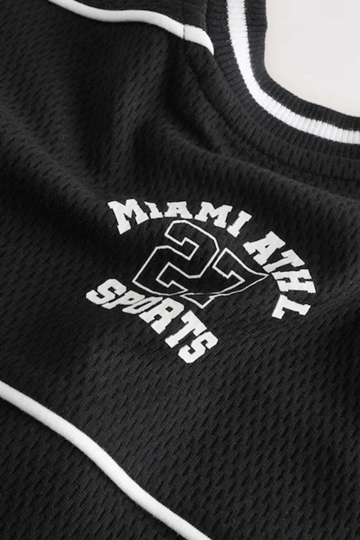 Close-up of black jersey chest logo with Miami 27 SPORTS text