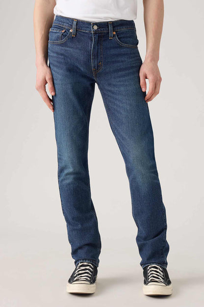 Levi's dark indigo denim jeans close-up, front pockets and button waistband