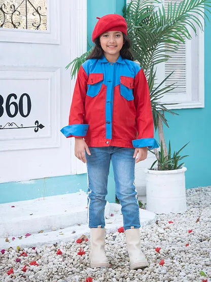 Kids red and blue button jacket with two flap pockets, worn with light blue jeans