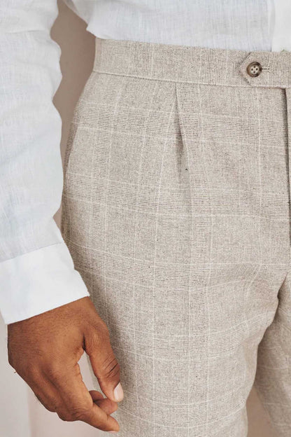 Men's suit trouser front pocket and waistband seam, light beige textured fabric