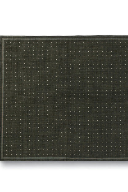 Green fabric square laid flat with tiny dot pattern and dark edge border