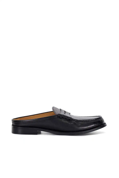 Black slip-on mule loafer profile with low block heel and stitched upper