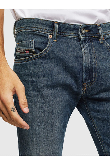 Blue denim jeans front close-up with pocket stitching and button