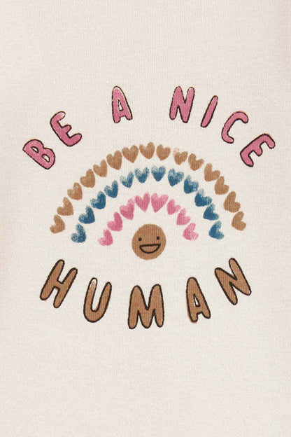 Ivory bodysuit fabric close-up with Be a Nice Human text and rainbow smiley