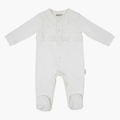 Cream baby romper with long sleeves and feet, textured floral yoke, giggles® logo