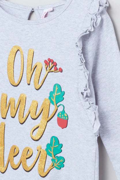 Light blue baby top close-up with ruffled sleeves and “Oh my deer” glitter slogan
