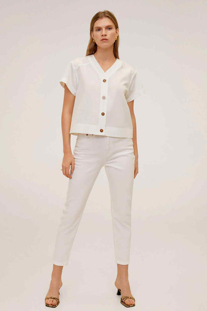 White short-sleeve V-neck top with button front and matching white pants