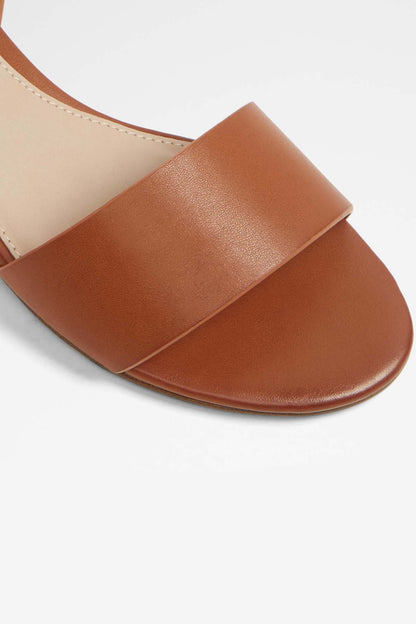 ALDO cognac leather slide sandal close-up of wide toe strap and stitching