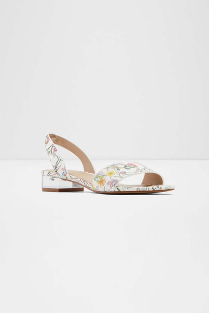 White floral slingback sandals with low block heel, open toe and wrapped strap